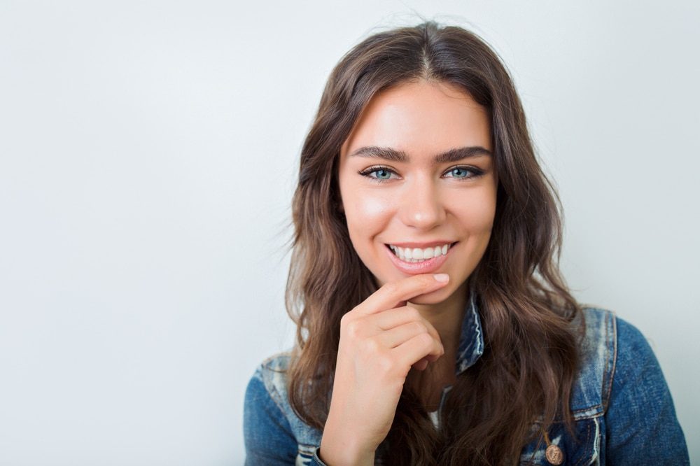 A woman smiling, showing bright natural teeth