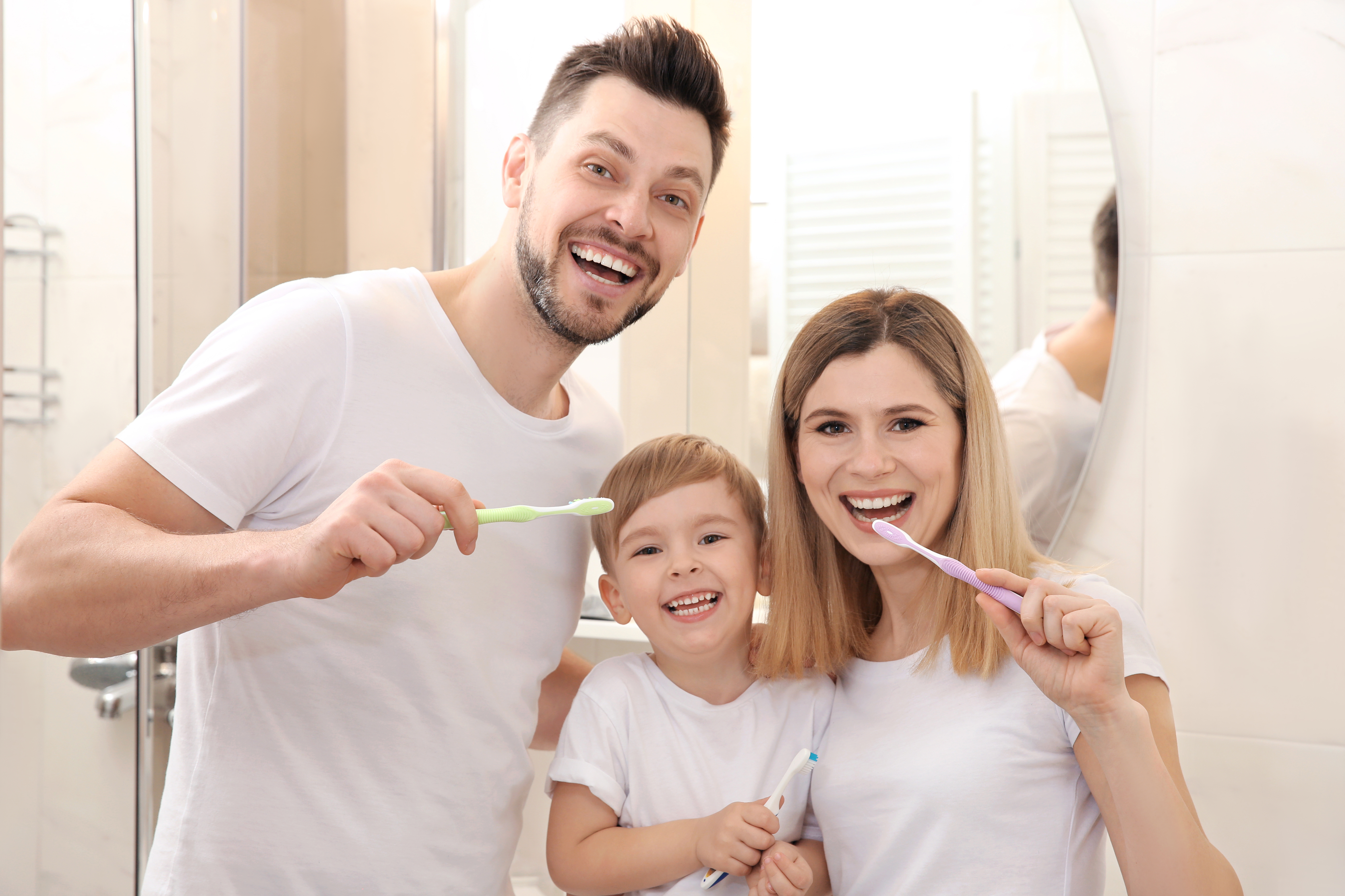 family holding tooth brushes